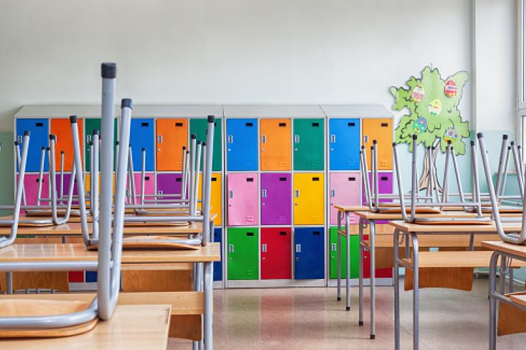 Chairs on table with coloured lockers in the background