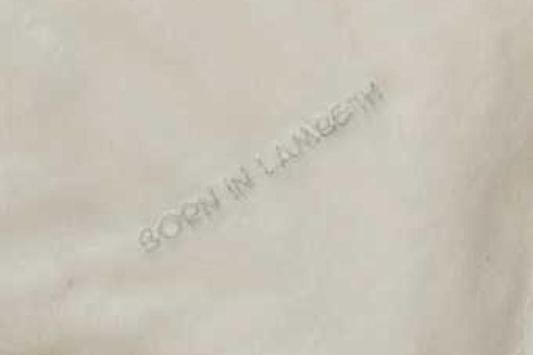 Born in Lambeth undated comforter with silver lettering - close up