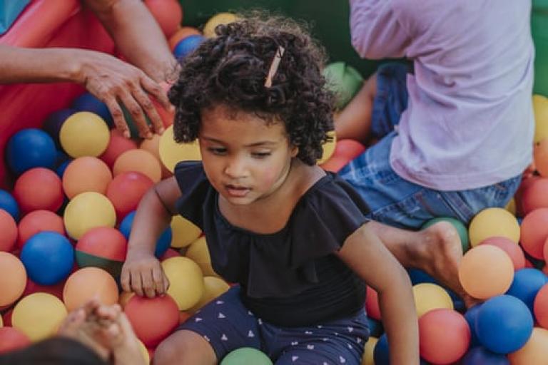 Child playing in a ballpit