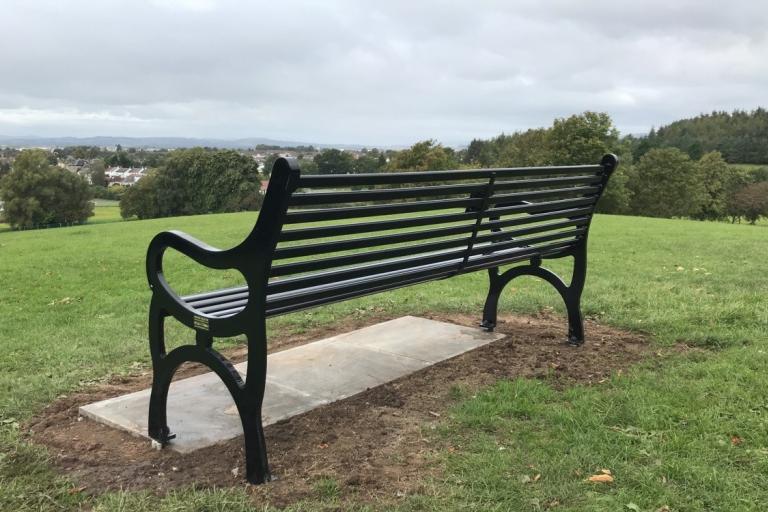 photo of a commemorative all black KC style memorial bench