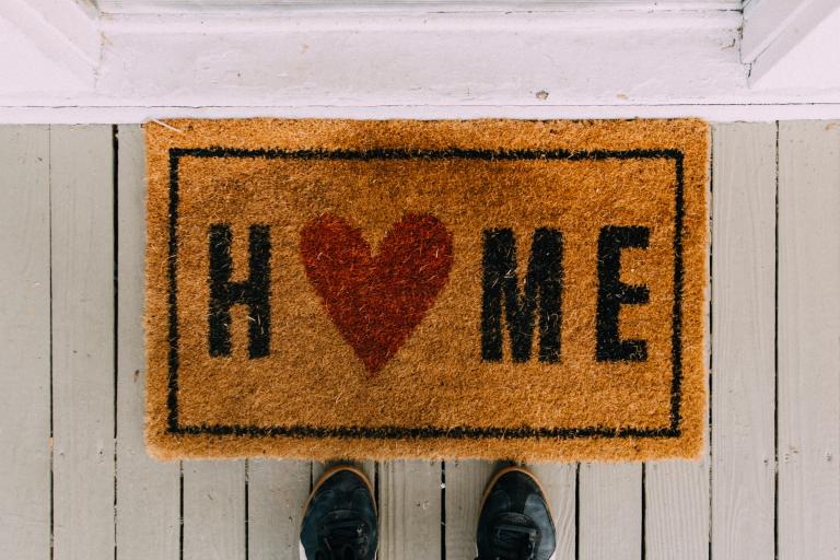 Doormat with home written on it