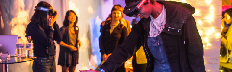 Young people using virtual reality headgear at a tech event