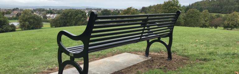 photo of a commemorative all black KC style memorial bench