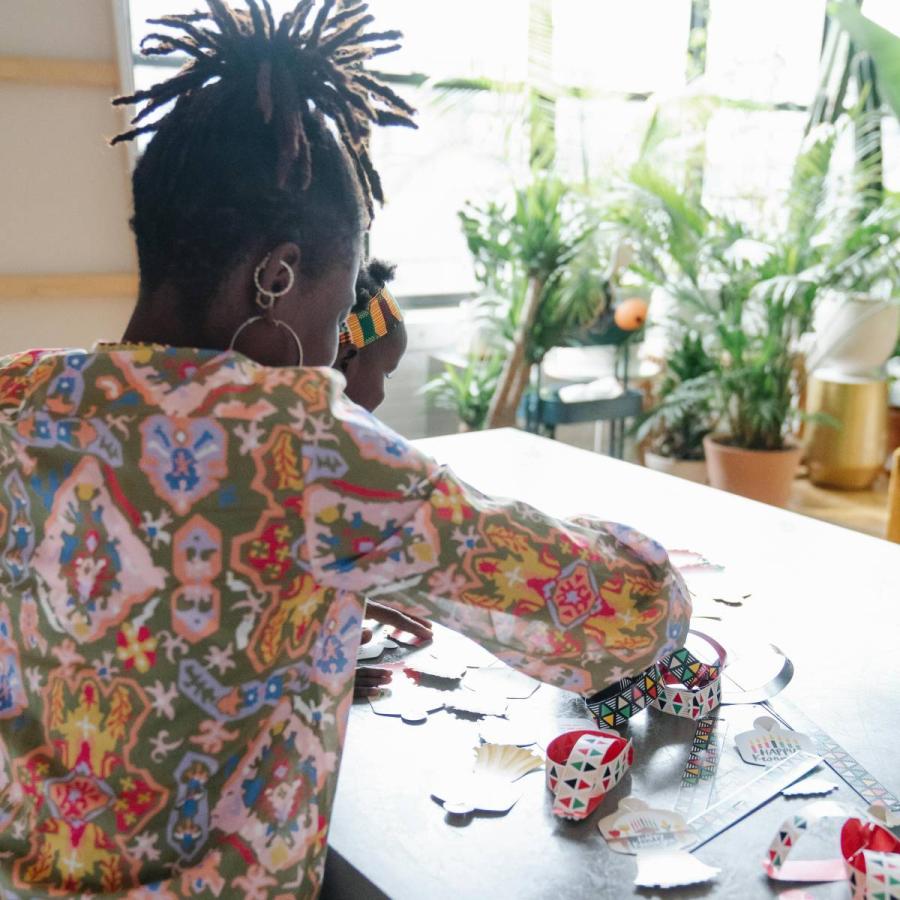 A mother making badges with her daughter