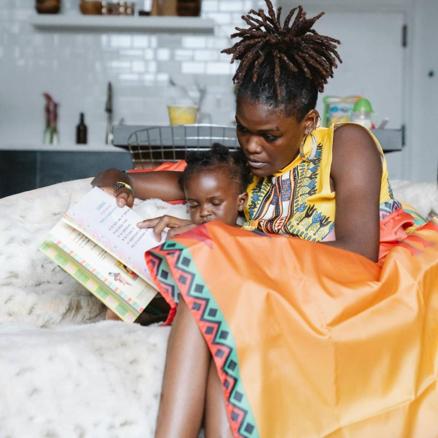 a mother reading to her daughter