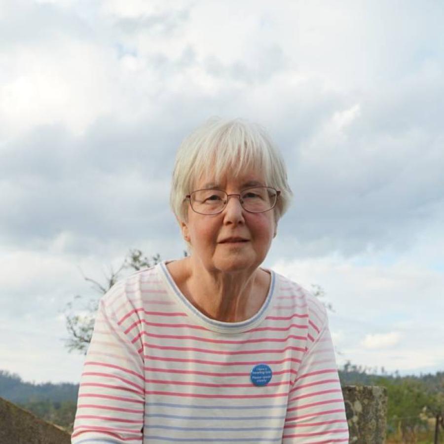 Woman standing beside a grave